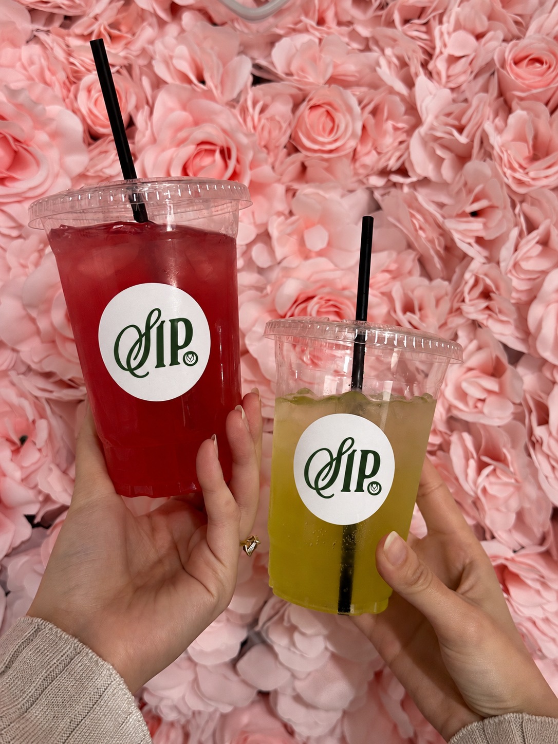 Guests holding colourful SIP. drinks at an event