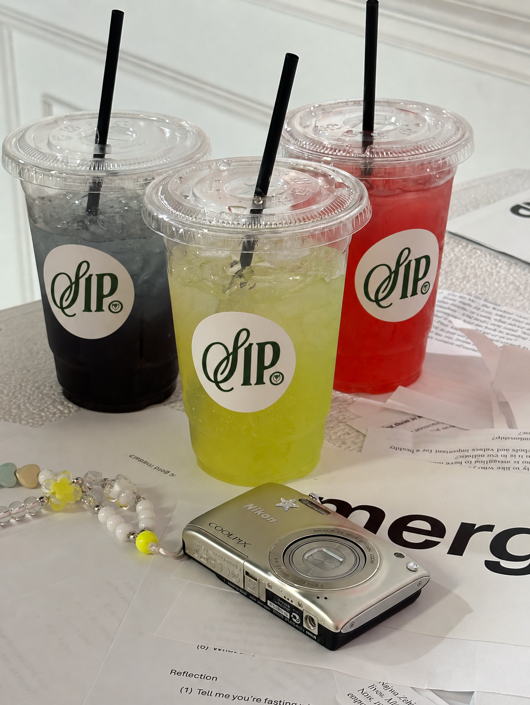 Three colourful refreshments in branded SIP. cups