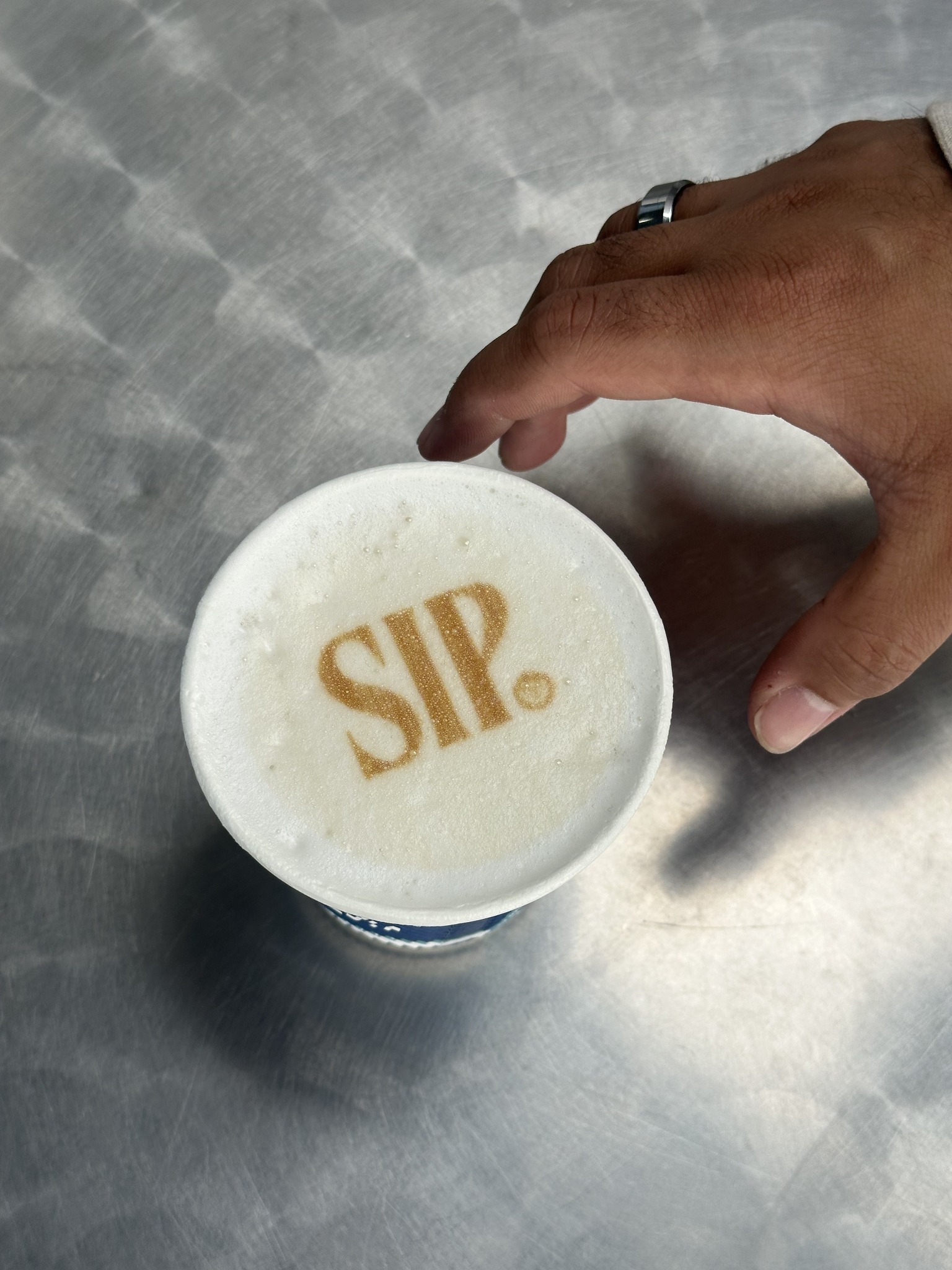 SIP. logo printed in the foam of a freshly made coffee
